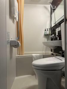 a white bathroom with a sink and a toilet at ELE Hotel 東日本橋 in Tokyo