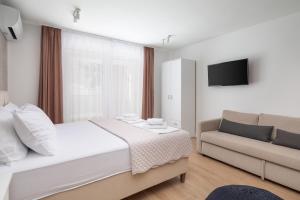 Postel nebo postele na pokoji v ubytování Kovač Family Suites