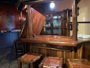 un bar con due sgabelli in legno in una stanza di Ivory Sands Safari Lodge a Marloth Park