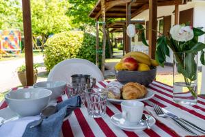 a table with a bowl of fruit and a plate of food at La Conchiglia in Chioggia