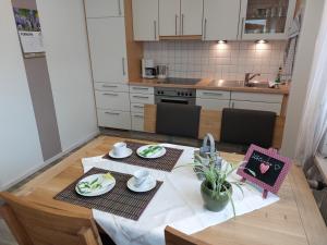 a kitchen with a table with two plates of food at Ferienwohnung Leute in Tengen