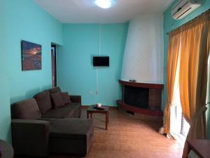 sala de estar con sofá y chimenea en Sofi's apartment, en Agios Konstantinos