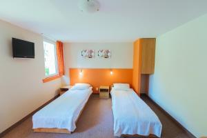 a hospital room with two beds and a tv at Hotel Pod Sosnami in Osieck +42 photos
