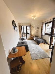 a bedroom with two beds and a table in it at Czarne jagody in Kościelisko