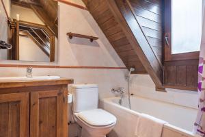 un bagno con un water, un lavandino e una vasca di Luderna - Dúplex Nòdes II ad Arties