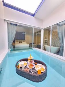 a tray of breakfast food on a table in a room at Skyline Resort in Ban Khlong Lat Bua Khao