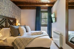 Katil atau katil-katil dalam bilik di Luderna - Apartamento Val de Ruda B21 Blanhiblar