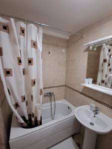 a bathroom with a sink and a bath tub and a toilet at Belveder Montenegro in Rafailovici +134 photos