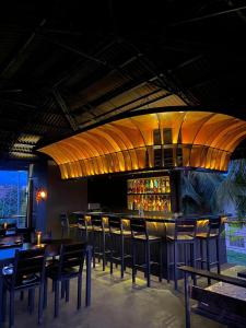 a bar with tables and chairs in a restaurant at Mojo Hostel in Puerto Princesa City