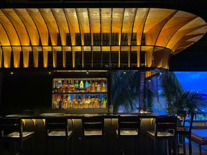 a bar in a restaurant with a bunch of drinks at Mojo Hostel in Puerto Princesa City