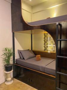 a bunk bed in a room with a mirror at Mojo Hostel in Puerto Princesa City