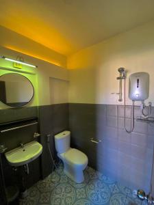 a bathroom with a toilet and a sink at Mojo Hostel in Puerto Princesa City