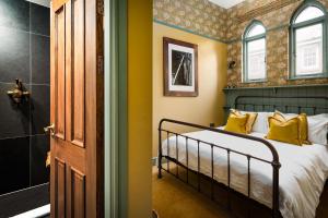 a bedroom with a bed with yellow pillows at Old Town Luxury, By The Sea in Scarborough