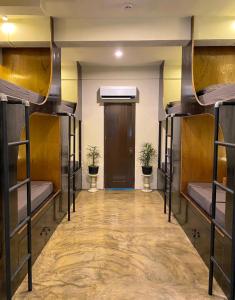 a room with several bunk beds with a door at Mojo Hostel in Puerto Princesa City