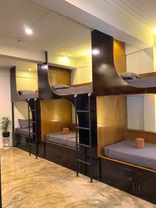 a group of three bunk beds in a room at Mojo Hostel in Puerto Princesa City