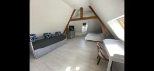 a bedroom with a bed and a desk in a attic at B&B - Villa des Remparts - Ardres proche Calais-St Omer-Dunkerque in Ardres
