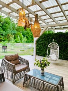 a patio with a chair and a table at Family house in Druskininkai