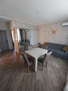 un soggiorno con tavolo, sedie e divano di Etci hotel & restaurant a Gabala