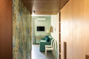 a living room with a blue couch and a television at Olga's Apartment a Mondello by Wonderful Italy in Mondello