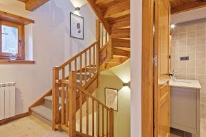 a bathroom with a wooden staircase and a sink at Luderna - Casa Eth Farrow I in Vielha +14 photos