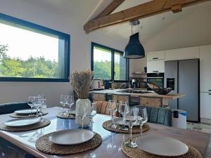a kitchen with a table with wine glasses on it at Les Suites du Littoral in Plouézec