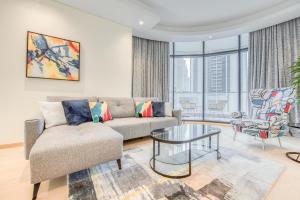 a living room with a couch and a table at RH- Downtown Delight, spacious 01BR near Dubai Mall & Burj Khalifa, RP Heights in Dubai