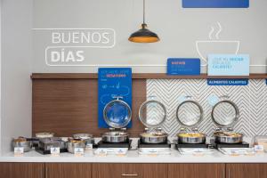 a bakery counter with a bunch of pots and pans at Holiday Inn Express Guadalajara Iteso, an IHG Hotel in Guadalajara