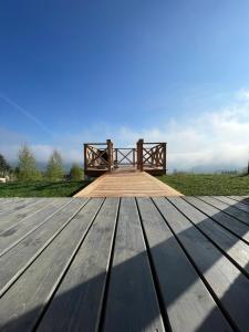 a wooden bench sitting on top of a wooden boardwalk at Somnium Pieniny in Tylka