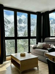 a living room with a view of snow covered mountains at Lux Renard "Acceso directo a pistas" in Pas de la Casa