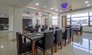 a dining room with a table and chairs at Treebo Trend Stotrak S N Residency - Mussoorie in Mussoorie