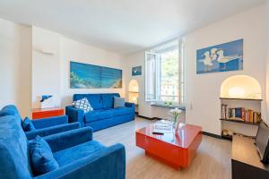 a living room with blue couches and a coffee table at Portofino Apartment Sea View Dream - Happy Rentals in Portofino