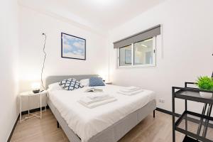 a bedroom with a bed with white sheets and a window at Portofino Apartment Sea View Dream - Happy Rentals in Portofino