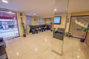a large living room with a couch and a tv at Supreme Victoria in Varna City