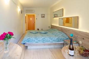 a bedroom with a bed and a table with a vase of flowers at Supreme Victoria in Varna City