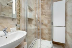 a bathroom with a sink and a shower at Beautiful Apartment with a Spacious Balcony in Wrocław by Renters in Wrocław