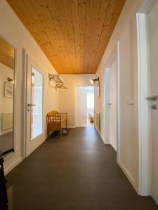 an empty hallway with a wooden ceiling at Almufer-Appartements in Grünau im Almtal