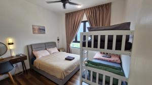 a bedroom with two bunk beds and a desk at H&W Sunway Onsen Suite 4-7pax near Lost World of Tambun Ipoh in Ipoh +95 photos