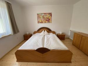 a bedroom with a bed with a bow on it at Almufer-Appartements in Grünau im Almtal