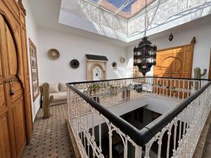 a room with a staircase with a chandelier at Riad Sarah Sabrina in Marrakesh