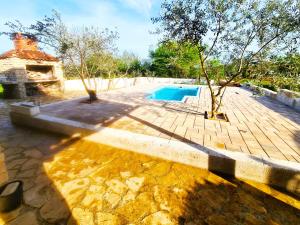 a backyard with a swimming pool and a house at Romantic Villa Cherry in Zadar