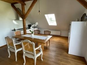 a kitchen and dining room with a table and a refrigerator at Aich22 in Peißenberg +27 photos