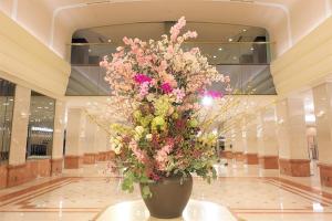 a large vase filled with flowers in a lobby at Keio Plaza Hotel Tokyo in Tokyo