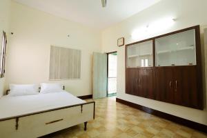 a bedroom with a bed and a large window at 2 Room and Kitchen Furnished Set-up Near Benaras Railway Station in Varanasi