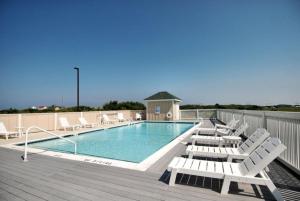 a swimming pool with lounge chairs on a deck at LSC201-Gracens Sweet Retreat1 Min Drive to Beach in Nags Head