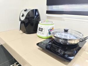a kitchen counter with a pot on top of a toaster at Homestay Sitiawan 53 in Sitiawan