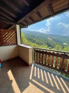 a balcony of a house with a view of the mountains at Residenza Riva Wellness Apartment Spa in Abetone