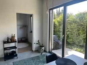 a living room with a large sliding glass door at Modernes Tiny Appartement in Lage in Lage