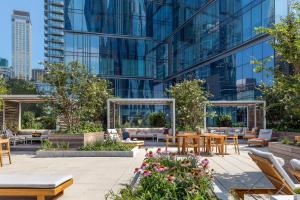 a patio with tables and chairs in front of a building at Club Quarters 3 bedroom Boston in Cambridge