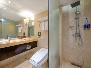 a bathroom with a toilet and a shower at Dorsett Chengdu in Chengdu