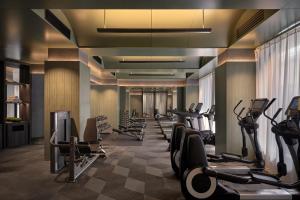 a gym with a row of treadmills and machines at Regent Shanghai on the Bund in Shanghai